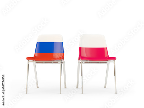 Two chairs with flags of Russia and poland isolated on white