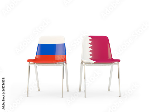 Two chairs with flags of Russia and qatar isolated on white
