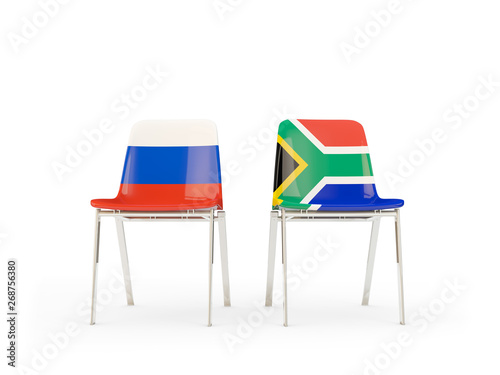 Two chairs with flags of Russia and south africa isolated on white
