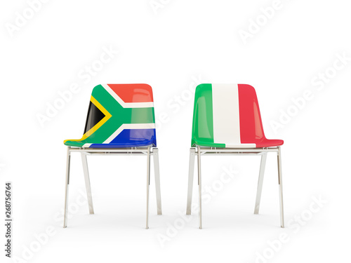 Two chairs with flags of South Africa and italy isolated on white