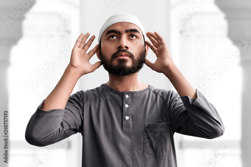 Religious asian muslim man praying