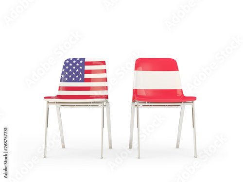 Two chairs with flags of United States and austria isolated on white