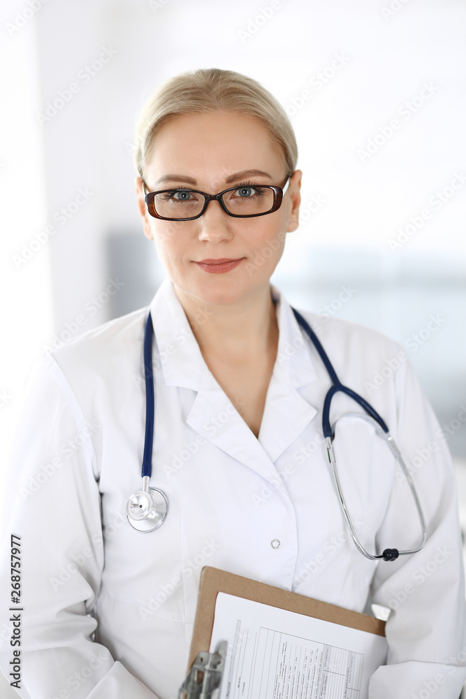 Doctor woman adult standing straight with arms crossed, portrait. Perfect medical service in clinic. Medicine and healthcare concepts Doctor woman adult standing straight with arms crossed, portrait. Perfect medical service in clinic. Medicine and healthcare concepts