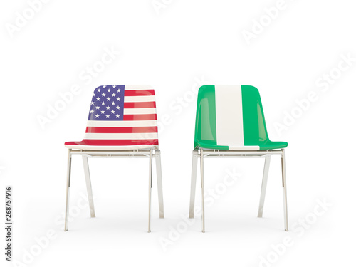 Two chairs with flags of United States and nigeria isolated on white