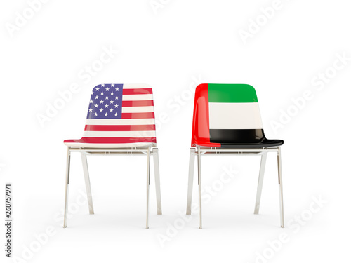 Two chairs with flags of United States and united arab emirates isolated on white