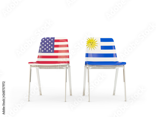 Two chairs with flags of United States and uruguay isolated on white