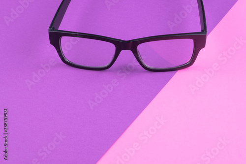 health concept,eye glasses spectacles with shiny black frame on pastel color background.copy space for text