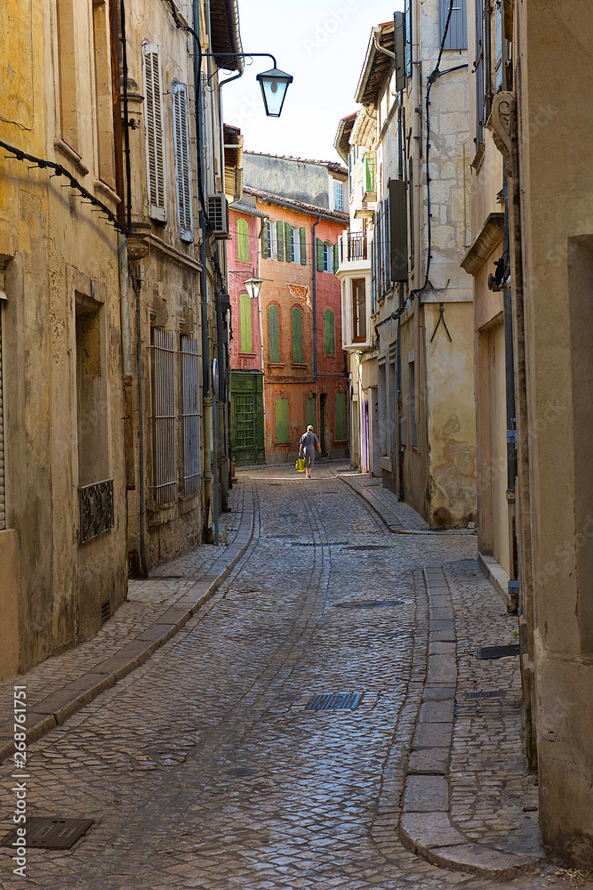 people walking in a narrow street 