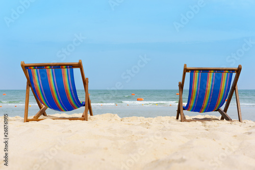 Two canvas chairs on the beach background. On white sand and blue sea so beautiful and relax  view.