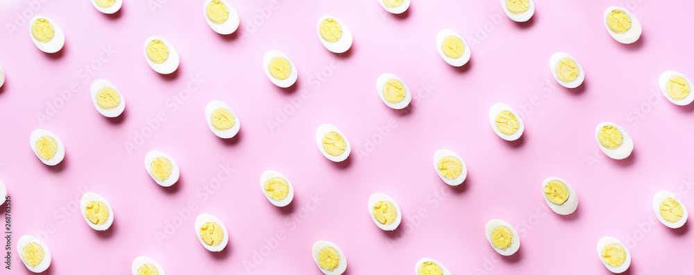 Food concept with boiled eggs pattern on pink background. Top view. Creative pattern in minimal style. Flat lay. Banner Food concept with boiled eggs pattern on pink background. Top view. Creative pattern in minimal style. Flat lay. Banner