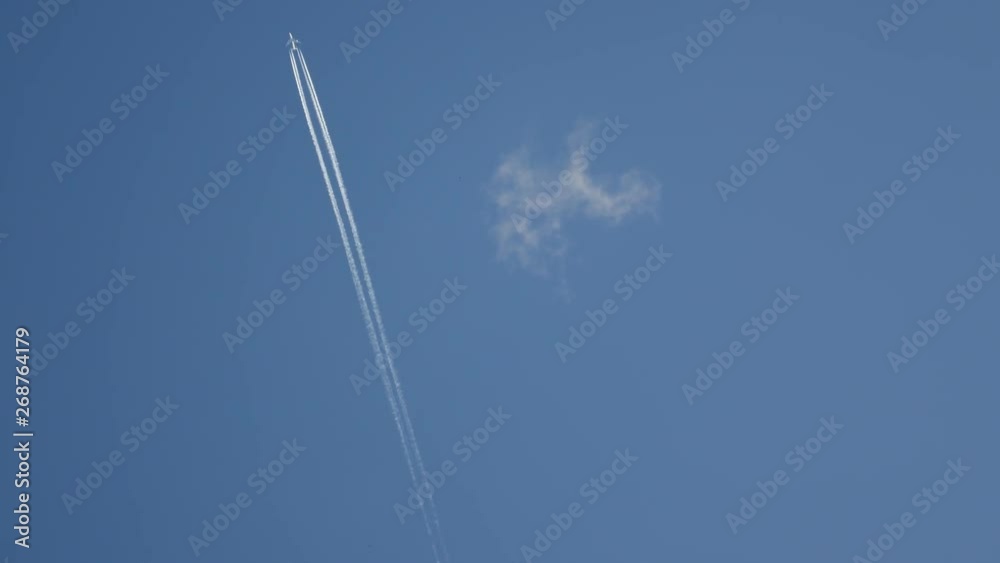 Plane in the sky, flying at cruising altitude, white trail in the sky. Plane in the sky, flying at cruising altitude, white trail in the sky.