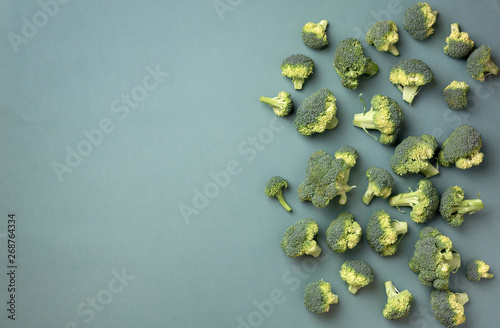 Creative layout of fresh broccoli on green paper background. Top view. Food pattern in minimal style. Flat lay. Banner