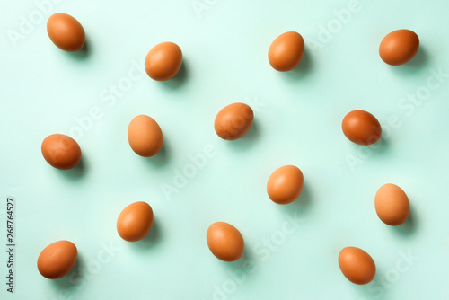 Food concept with white chicken eggs on blue background. Top view. Creative pattern in minimal style. Flat lay.