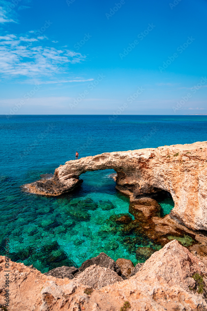Beautiful turquoise clean water and blue sky in famous touristic Ayia Napa, Paralimni, Cyprus on a sunny day with amazing rock formations and cliffs.