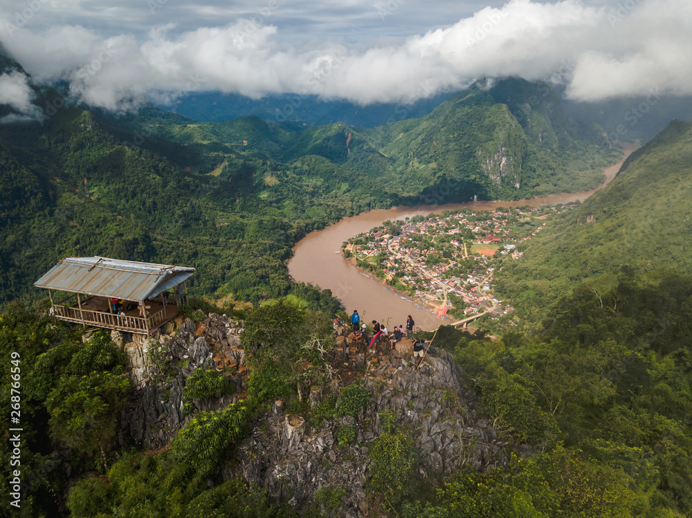 View from the top Viewpoint of Nong Khiaw, Laos. Stunning scenery with lush green mountains and mysterious clouds.