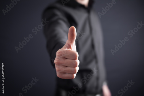 Man making a thumbs up sign.