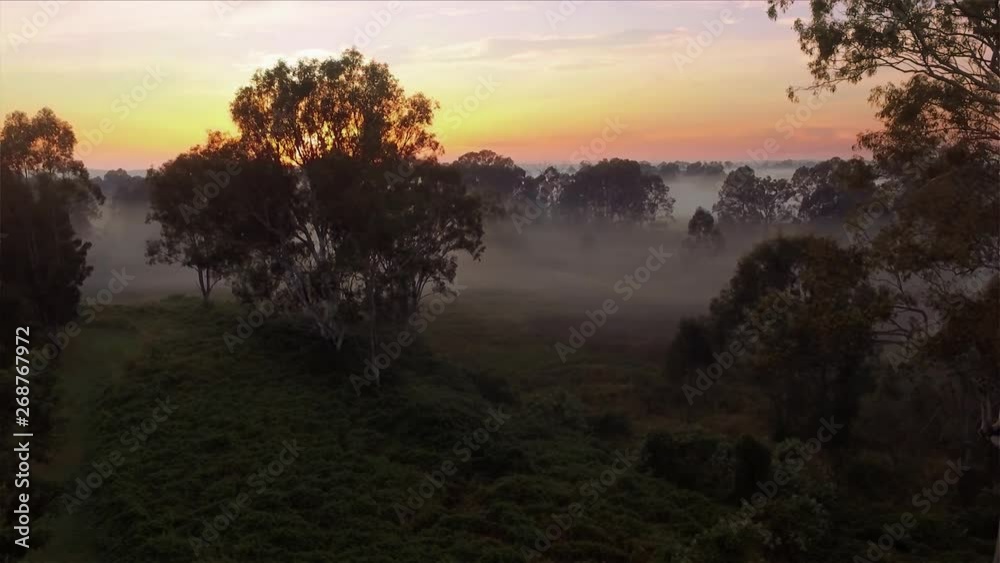 Stunning drone rising shot of a beautiful misty sunrise in the outback in Queensland Australia Stunning drone rising shot of a beautiful misty sunrise in the outback in Queensland Australia