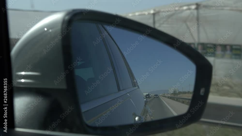 Looking in the side mirror of a crar Looking in the side mirror of a crar