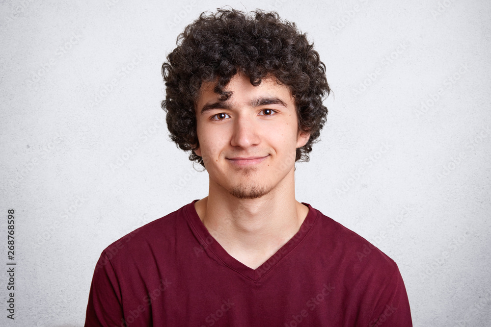 Portrait of young attractive stylish fashion man, posing against white studio background, handsome happy male, has pleasant facial expressions, looking directly at camera, wearing casual shirt. Portrait of young attractive stylish fashion man, posing against white studio background, handsome happy male, has pleasant facial expressions, looking directly at camera, wearing casual shirt.