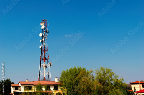 wireless gsm antenna tower installed in residential area with copy space photo