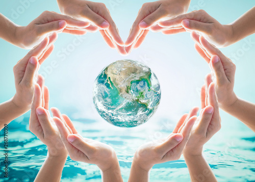 Fototapeta Naklejka Na Ścianę i Meble -  World water day and environmental protection concept with heart hands love earth in community volunteer's hands. Element of this image furnished by NASA