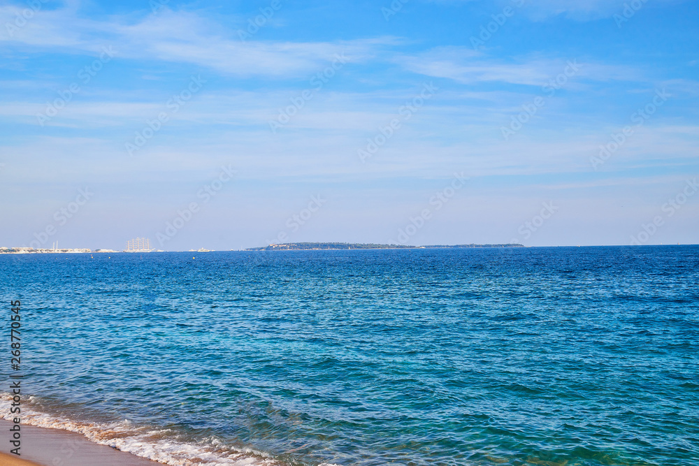 Sea, blue sky, white clouds and wave on a Sunny day