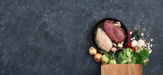 Paper bag vegetables, fruit and meat on dark background with copy space top view. Bag food concept