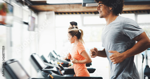 Group of friends exercising on treadmill machine