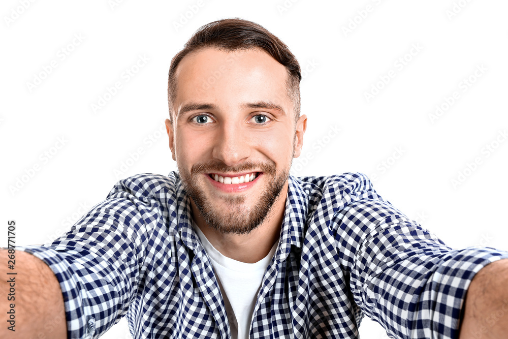 Portrait of handsome man taking selfie on white background Portrait of handsome man taking selfie on white background