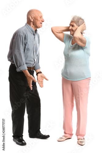 Arguing senior couple on white background