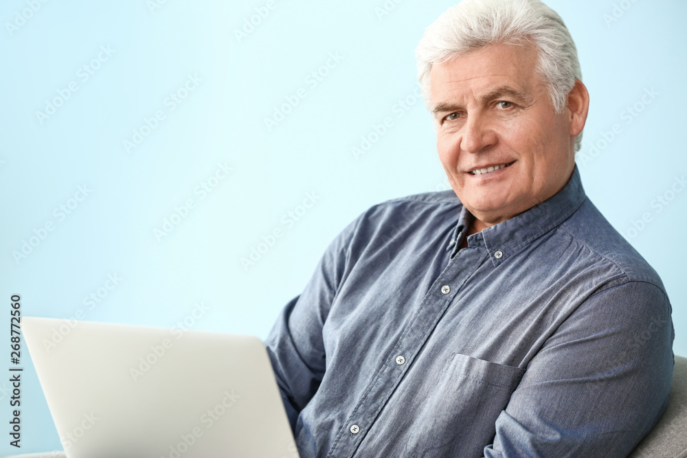 Portrait of handsome senior man with laptop at home Portrait of handsome senior man with laptop at home