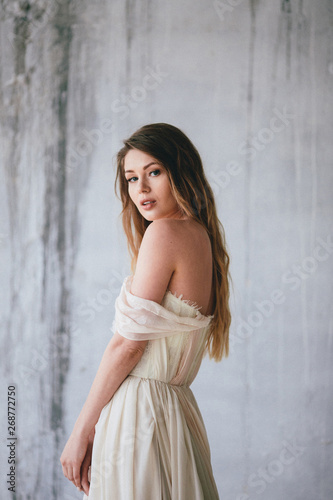 Fashion model in a beautiful beige flowing dress. © gartmanart