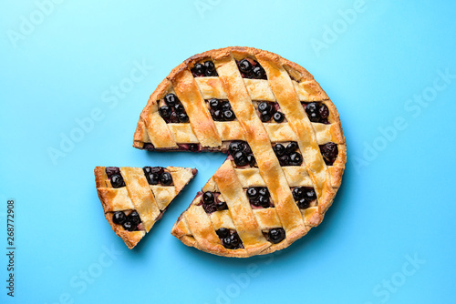 Tasty blueberry pie on color background photo
