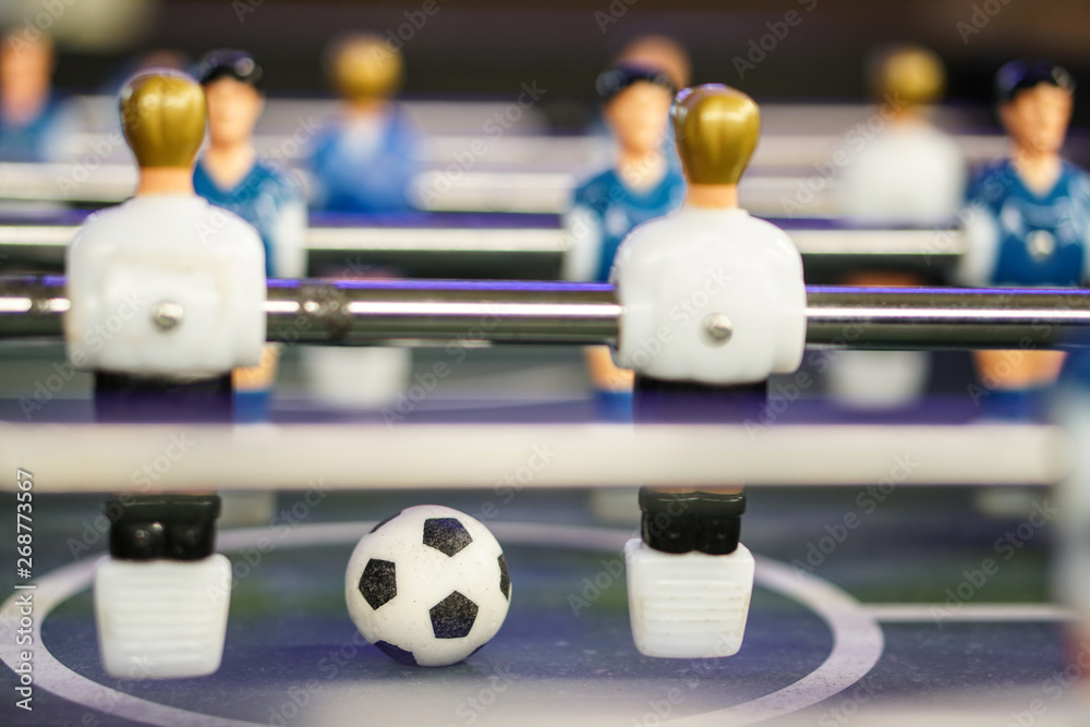 Table football soccer game kicker . Football ball on the playing field Table football soccer game kicker . Football ball on the playing field