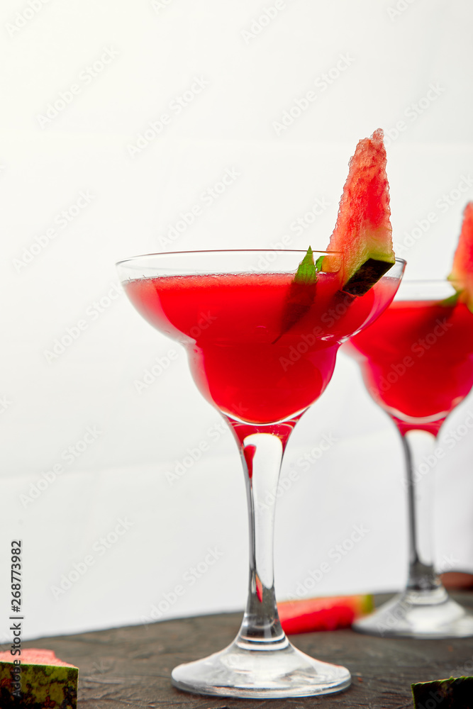 Watermelon margarita cocktail on black background. Fresh watermelon lemonade Watermelon margarita cocktail on black background. Fresh watermelon lemonade