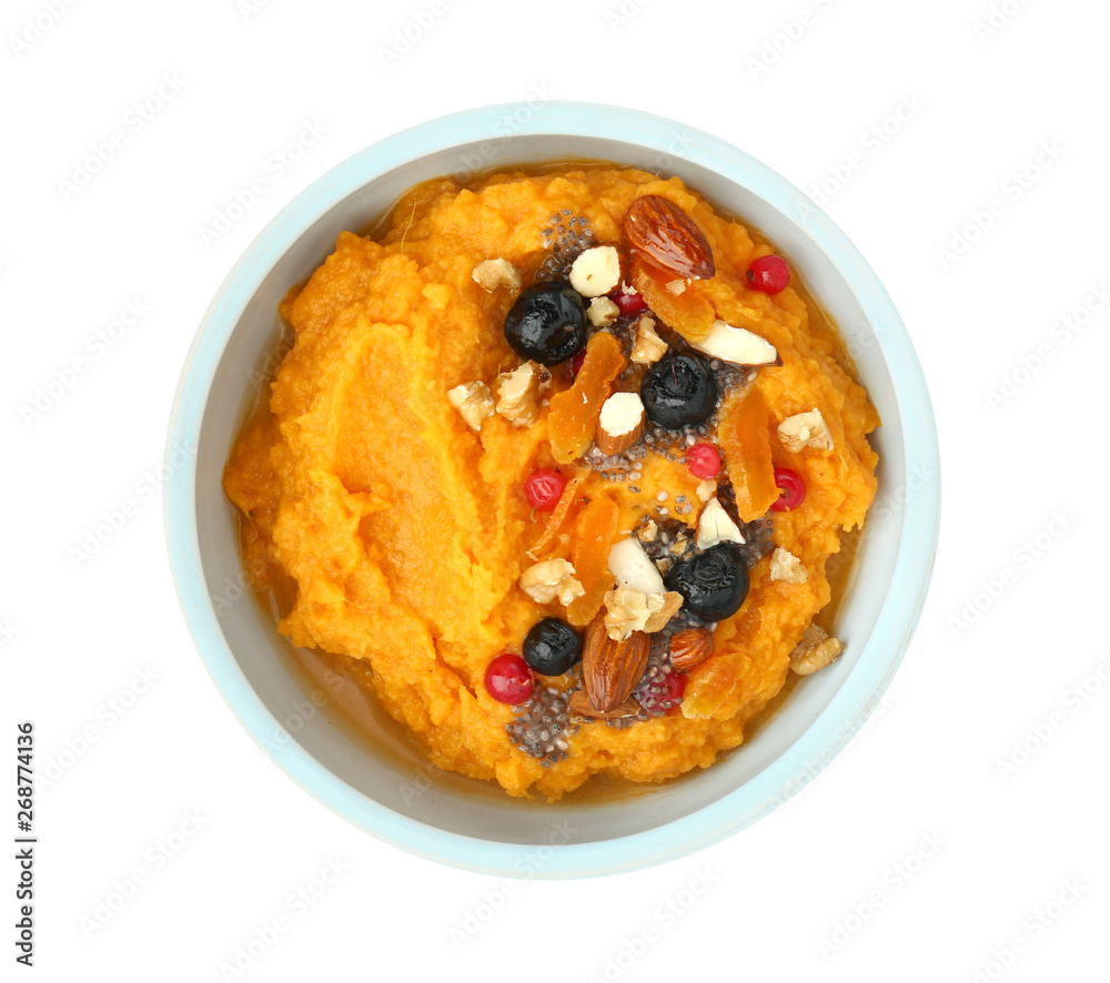 Bowl with mashed sweet potato, nuts and berries on white background Bowl with mashed sweet potato, nuts and berries on white background