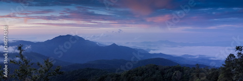 Panorama sunrise at Doi Inthanon, mountain view misty morning of top hills around with sea of fog with cloudy sky background, KM.41 View Point Doi Inthanon, Chiang Mai, Thailand.