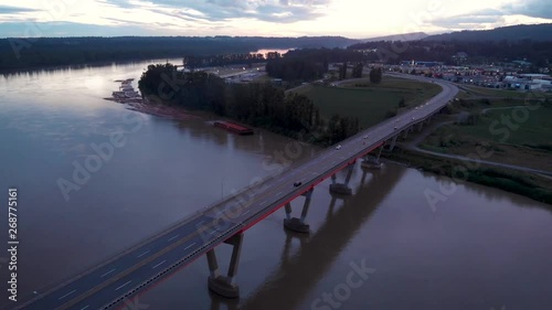 Aerial view of the Mission River bridge at dusk with cars commuting across it. photo