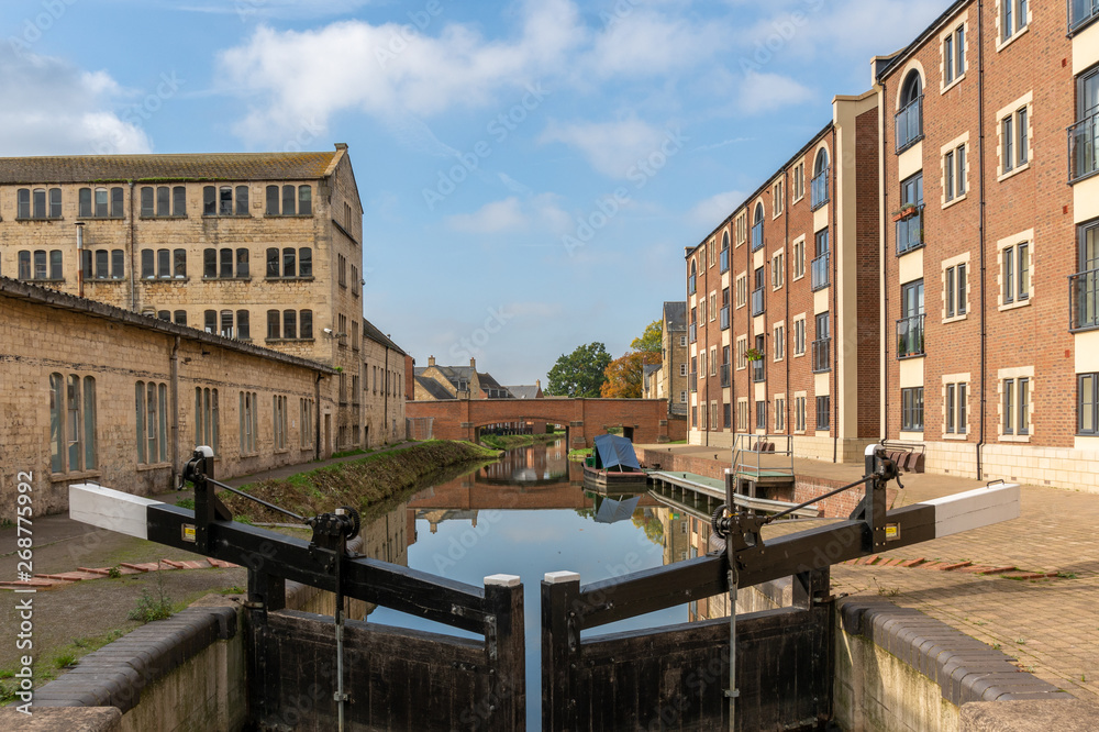 The restored Stroudwater canal and Oils Mills Bridge running through Ebley Mills, Stroud, England