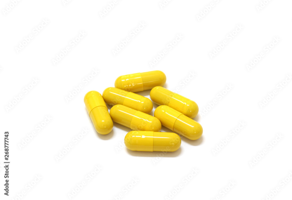 Medicine yellow pills on white background with copy space Medicine yellow pills on white background with copy space