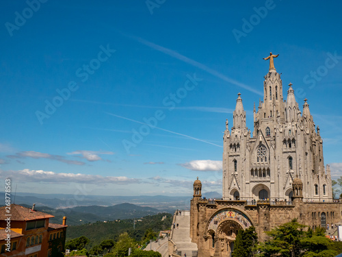 Tibidabo Cathedral. Temple of the Sacred Heart of Jesus at Mount Tibidabo. Barcelona, Spain. Blue sky with cloud of spring day. Famous landmark in Catalonia.