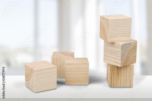 Wooden cubes on table background