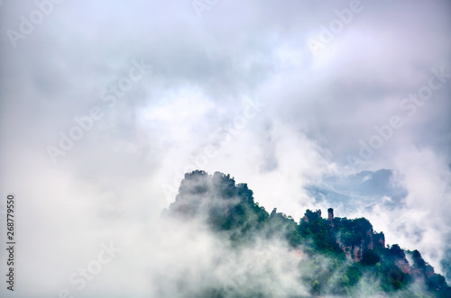 Zhangjiajie National park. Famous tourist attraction in Wulingyuan, Hunan, China. Amazing natural landscape with stone pillars quartz mountains in fog and clouds