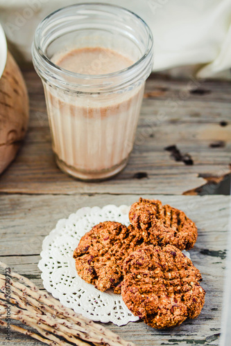 Homemade wholegrain cookies with oatmeal, lin and sesame seeds on rustic wooden table. Healthy vegan wholegrain cookies. Top view.
