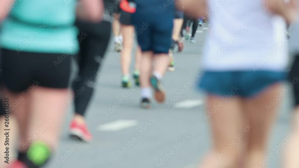Marathon running in the city. Feet of runners Marathon running in the city. Feet of runners