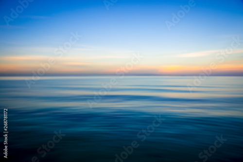 Slika na platnu Abstract view of the glassy smooth surface waves of a calm sea during the magic