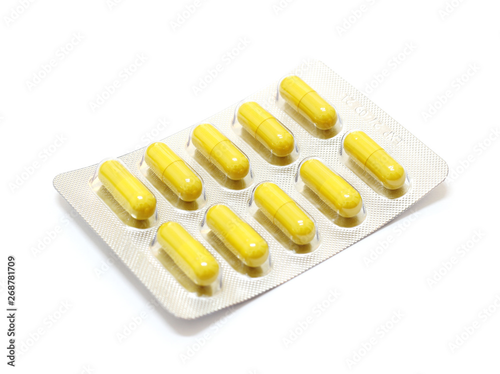 Medicine yellow pills on white background with copy space Medicine yellow pills on white background with copy space