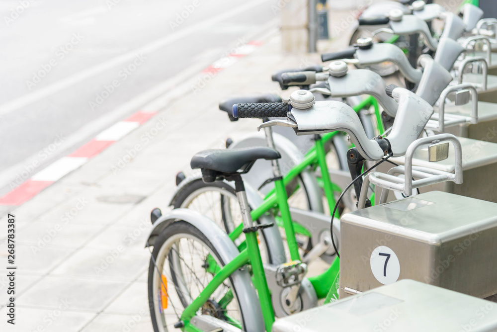 Obraz premium green bicycle for rent in city / bike for rent