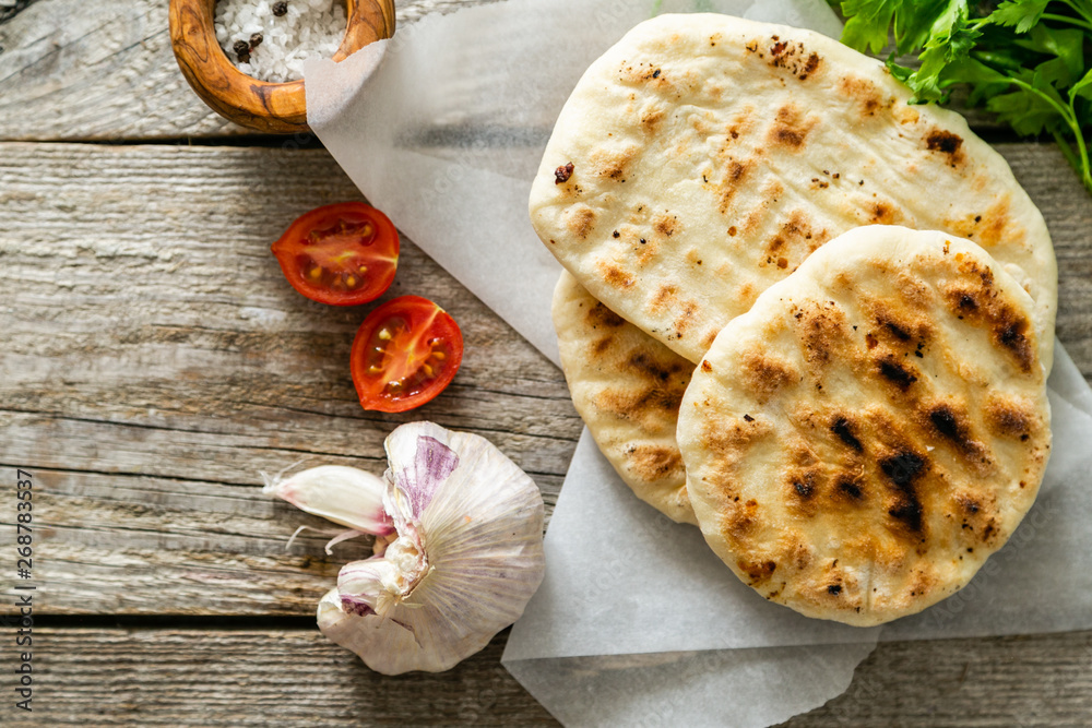 Traditional pita bread on rustic wood background, copy space Traditional pita bread on rustic wood background, copy space