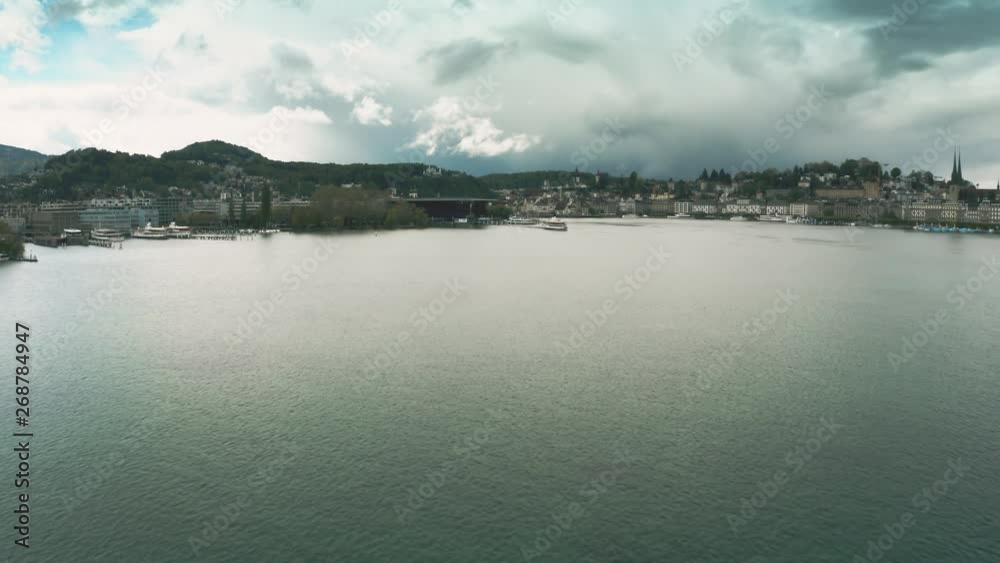 Aerial view of a tour ship and distant city of Lucerne, Switzerland Aerial view of a tour ship and distant city of Lucerne, Switzerland